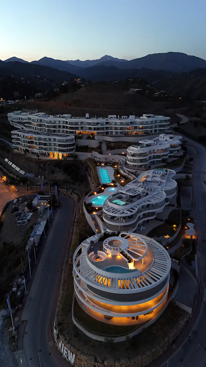 The circular building lit up at nightfall