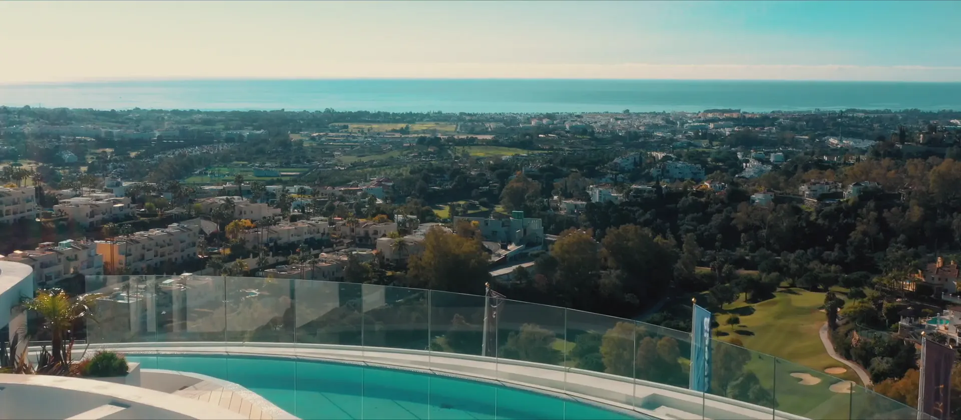 The rooftop pool and the view over the golf valley to the sea